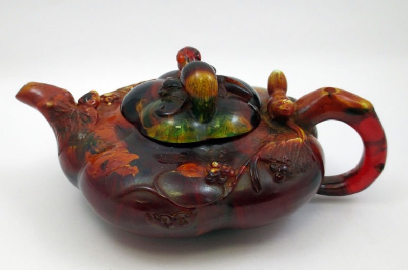 CHINESE COMPOSITE MULTI COLOR TEAPOT: Beautiful multi color teapot with a figural finial top. The finial is a lizard. Measures 7 3/4" spout to handle and 5 1/2" wide and 3 1/2" height.