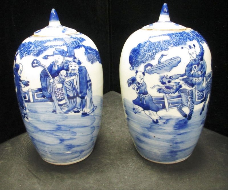2 CHINESE PORCELAIN BLUE & WHITE LIDDED VASES: Both of these lidded Vases depict scenes from the Imperial Household. With Servants fanning him the Young Prince rides a Foo Dog, The other has the Emperor surrounded by immortals holding a small chil