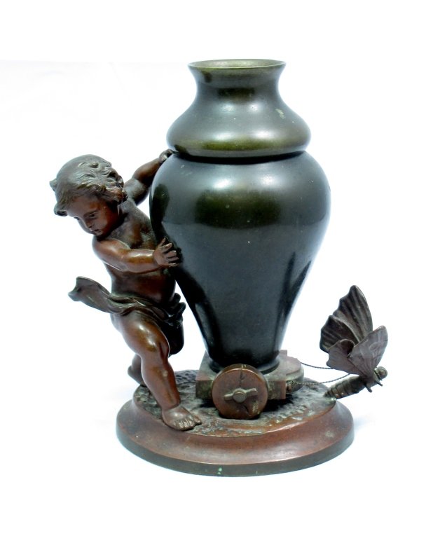 CHARLES GEORGES FERVILLE SUAN BRONZE SCULPTURE: Charles Georges Ferville-Suan (French, 1847-1925) Bronze sculpture original Butterfly pulling Large Urn with Cherub pushing from behind. Marked on bottom 1900 Georges. Measures 6 1/2" Tall by 5 1/2" W