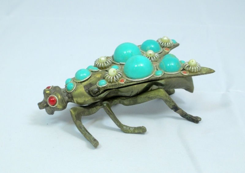 ANTIQUE BRASS AND TURQUOISE FLY PILL BOX: Lift up the wings for storage compartment. Comes with Pearl and Turquoise Wings Red Eyes over Brass. Measures 4 1/2" Long by 2" Wide by 1 1/2" Tall