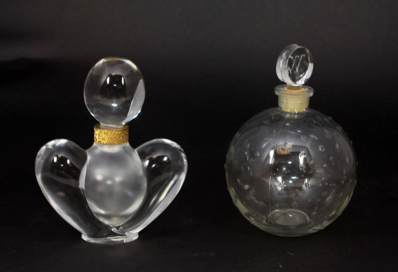 2 LALIQUE PERFUME BOTTLES: Heart Shaped Perfume Bottle with Frosted glass center & Gold gilt neck measures 5" Tall by 4" Wide bottom signed Lalique France. Round Ball shape Glass Perfume Bottle measures 5 1/2" Tall signed Laliq