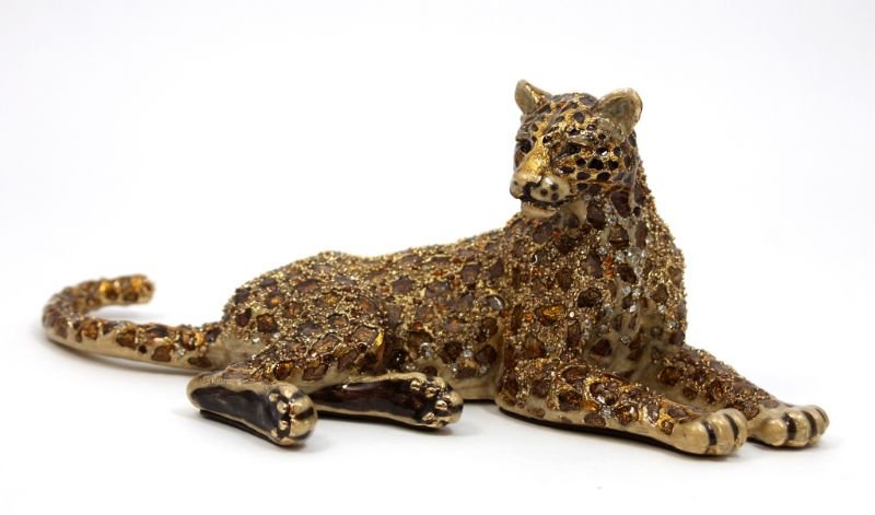 JAY STRONGWATER ENAMELED & JEWELED LEOPARD: A Jay Strongwater enameled and jeweled recumbent leopard sculpture. Includes original dust cover bag, box and papers. Measures 3 5/8" height x 9" length.