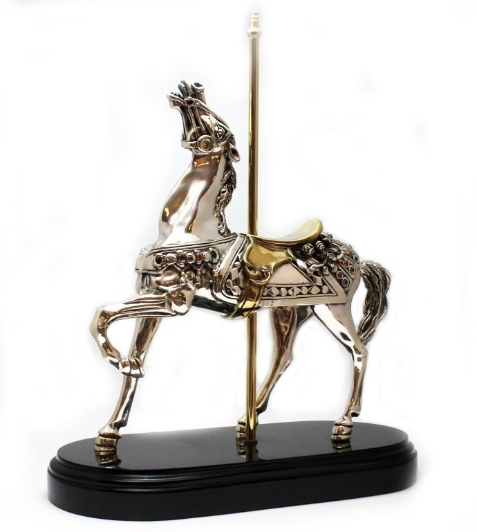 D'ARGENTA HORSE JEWELED SCULPTURE 59/500: D'Argenta silver and 24k gold plated horse sculpture depicting a carousel horse with one hoof and head up. Jeweled with multicolor stones. Signed to side of leg and numbered 59/500. Mounted on black l