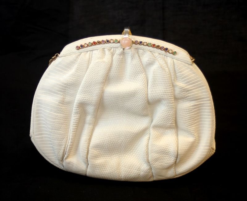 JUDITH LEIBER WHITE LIZARD SKIN LEATHER CLUTCH: A Judith Leiber designer lizard skin leather jeweled purse. Gold tone hardware. Brown silk interior with two pockets. Measures approx. 7 1/2" height x 8 1/2" width. Total weight of 307 grams.