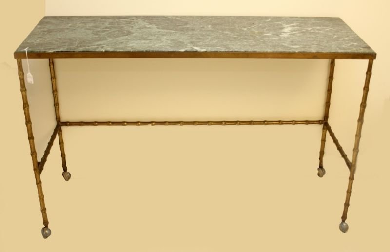 VINTAGE GILT METAL MARBLE TOP SIDE BAR TABLE: A vintage gilt brass buffet side bar table having a figural bamboo tree design. Has fitted green marble top. Wheels to feet for easy movement. Circa 1950's - 1960's. Measures 34" height x 54" width x