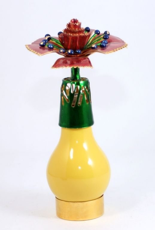LAMPE BERGER FRANCE ENAMELED FLORAL OIL LAMP: A Vintage Lampe Berger enameled figural floral oil lamp. Yellow enameled pear shape body with figural enameled cover. Gold metal hardware. Company marks to bottom. Measures 9 1/2" height x 5" diameter