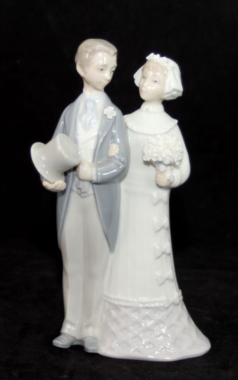 LLADRO PORCELAIN GROUP FIGURE 'WEDDING' 4804: Lladro Spanish porcelain group figure depicting a boy and girl holding flowers. Titled 'Wedding' or 'Boda de Antano'. Sculpted by Julio Fernandez. Last Retail: $200.00. Glazed finish. Issued 1972 and 