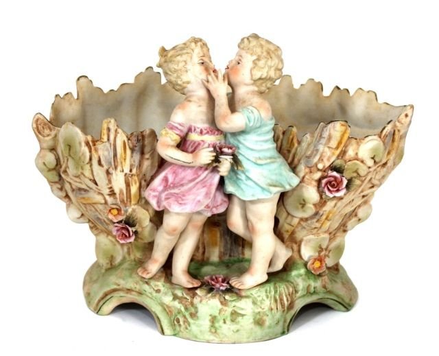 PORCELAIN DE PARIS BISQUE FIGURAL VASE: Stamped on bottom with crossed arrow marks. The figures fingers and Flowers are in perfect condition. Measures 7" Tall by 9" Long