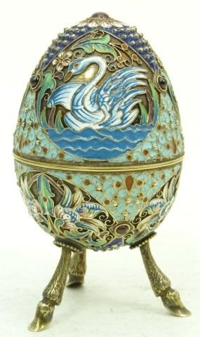RUSSIAN IMPERIAL SILVER & ENAMEL FOOTED EGG: RUSSIAN IMPERIAL SILVER & MULTI COLOR ENAMEL FOOTED EGG WITH A GOLD WASH INTERIOR . ENAMEL MULTI COLOR SWAN DESIGN WITH FOOTED ANIMAL LEGS. HOLDS THE MARKS OF WORKMASTERS AND SILVER PURITY MARK. MEASU