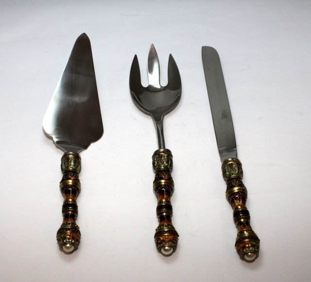 THREE ENAMELED AND JEWELED SERVING ITEMS: A lot of three enameled and jeweled serving items including a serving fork, pie/cake server and a carving knife. Largest piece 12" length. Total weight of 705 grams.