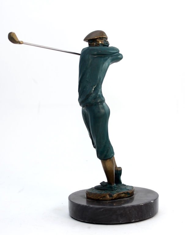 TOM BENNETT COLD PAINTED BRONZE GOLFER FIGURE: Tom Bennett (AMERICAN, 1928 - ) cold painted bronze sculpture depicting a golfer finishing a swing with a driver club. Etched signature to side of bronze base, dated 1994. Mounted on round black marbl