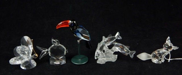 6 SWAROVSKI CRYSTAL ANIMAL FIGURES: A lot of 6 Swarovski Austrian crystal animal figures including a fox, butterfly, fish, group of fish and black tucan figure on perch with sterling silver leg and beak mount. Also includes the Trilo di