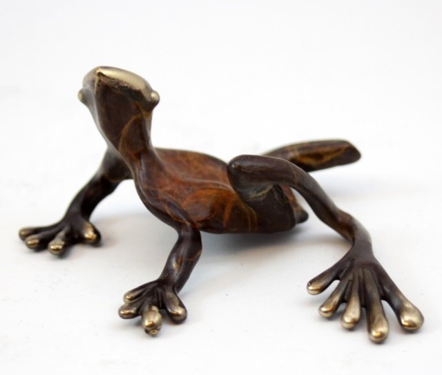 MICHAEL STOREY ACID STAINED METAL FROG SCULPTURE: An acid stained metal wall sculpture having brass tones with brown patina. Etched signature 'M. Storey' to bottom. Has ring mounted for hanging on wall. Measures 2" height x 4" width x 3 1/4" depth. T