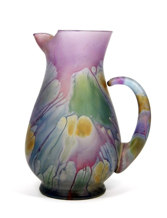 VINTAGE MURANO LAVENDER GLASS WATER PITCHER: A vintage Murano Italian art glass hand blown lavender water pitcher with ruffled ice stops. Worn label to bottom. Measures approx. 9" height. Total weight 751 grams.