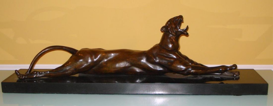 ANNA HYATT LARGE BRONZE SCULPTURE OF TIGER ON BASE: A very large bronze sculpture depicting a recumbent tiger as it yawns after Anna Vaughn Hyatt Huntington (AMERICAN, 1876 - 1973). Signed to side of bronze. Mounted on black marble base. Measures appro