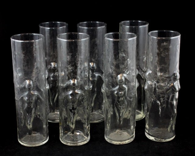 19 LIBBEY GLASS 'LA FEMME' 20oz NUDE TALL GLASSES: A set of 19 Libbey glass 'La Femme' 20 ounce tall glasses depicting raised nude females. Number 1620. Includes original cardboard box holding a dozen cups. Each measures approx. 8 3/4" height x 3" dia