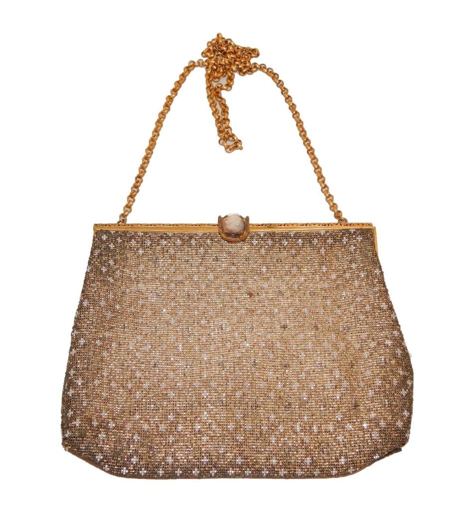 ANTIQUE FRENCH GOLD AND SILVER THREAD HANDBAG: Antique French gold and silver threaded beaded purse. Reticulated gilt floral frame. Beautiful carved mother of pearl cameo plaque set to clasp. Chain link strap with 19" drop. White silk interior wit