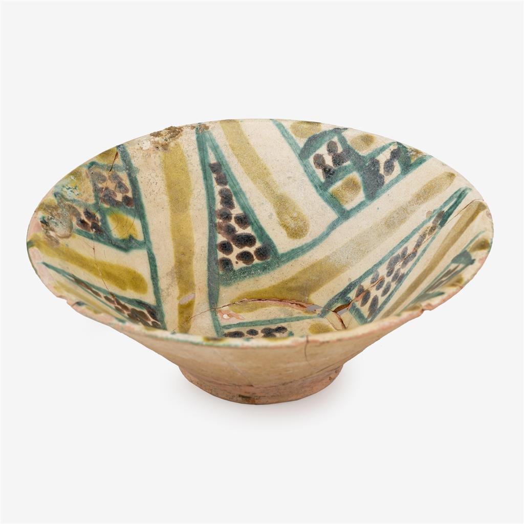Nishapur buffware pottery bowl: Nishapur buffware pottery bowl Wide flaring sides, the body painted in green, yellow and manganese brown with geometric designs. H: 3 5/8, D: 10 in.