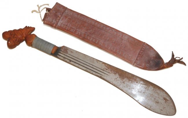 TRINIDADIAN FOLK MACHETE w ROBERT MOLE BLADE: Trinidadian folk mechete with Robert Mole & Son's blade and carved figural handle. Leather sheath with embossed 'TRINIDAD'. Measures approx. 24" length with handle and sheath (61cm). Total weight appr