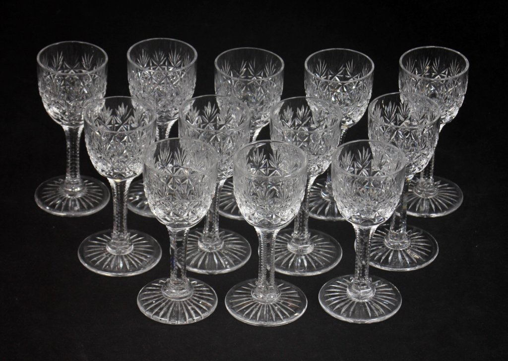 SET OF 12 TUDOR CRYSTAL JEWEL CORDIAL STEM GLASSES: Set of 12 Tudor English crystal cordial stem glasses in the 'Jewel' pattern. Bottoms hold Tudor acid marks. Cups measure 3 3/4" height. Total weight of approx. 777 grams.
