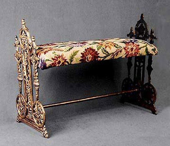 GARDEN GATE CAST IRON FOOT STOOL: GARDEN GATE CAST IRON FOOT STOOL - ANTIQUE FINISH - APPX 15"H X 19"W X 10.5"D - FABRIC MAY VARY - CAN BE EASILY RECOVERED