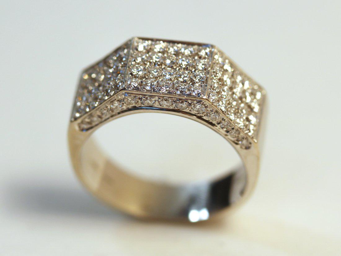 18K White Gold Ring Set with 82 Diamonds: Marked 750kt white gold ring with high polish finish. Ring has three angular sections, each with four rows of 5 pave set brilliant cut diamonds. The gallery of the ring is set with 13 bead set brillia