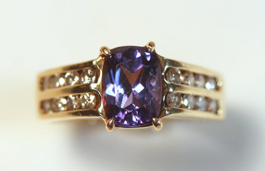 Tanzanite & Diamond 14K Ring: 1.90ct Tanzanite set in 14kt yellow gold with two channels, each filled with four brilliant cut diamonds for a total of sixteen diamonds. Color: I-J Clarity: SI-1 to SI-2 Cut: Good TW of Colored Stone