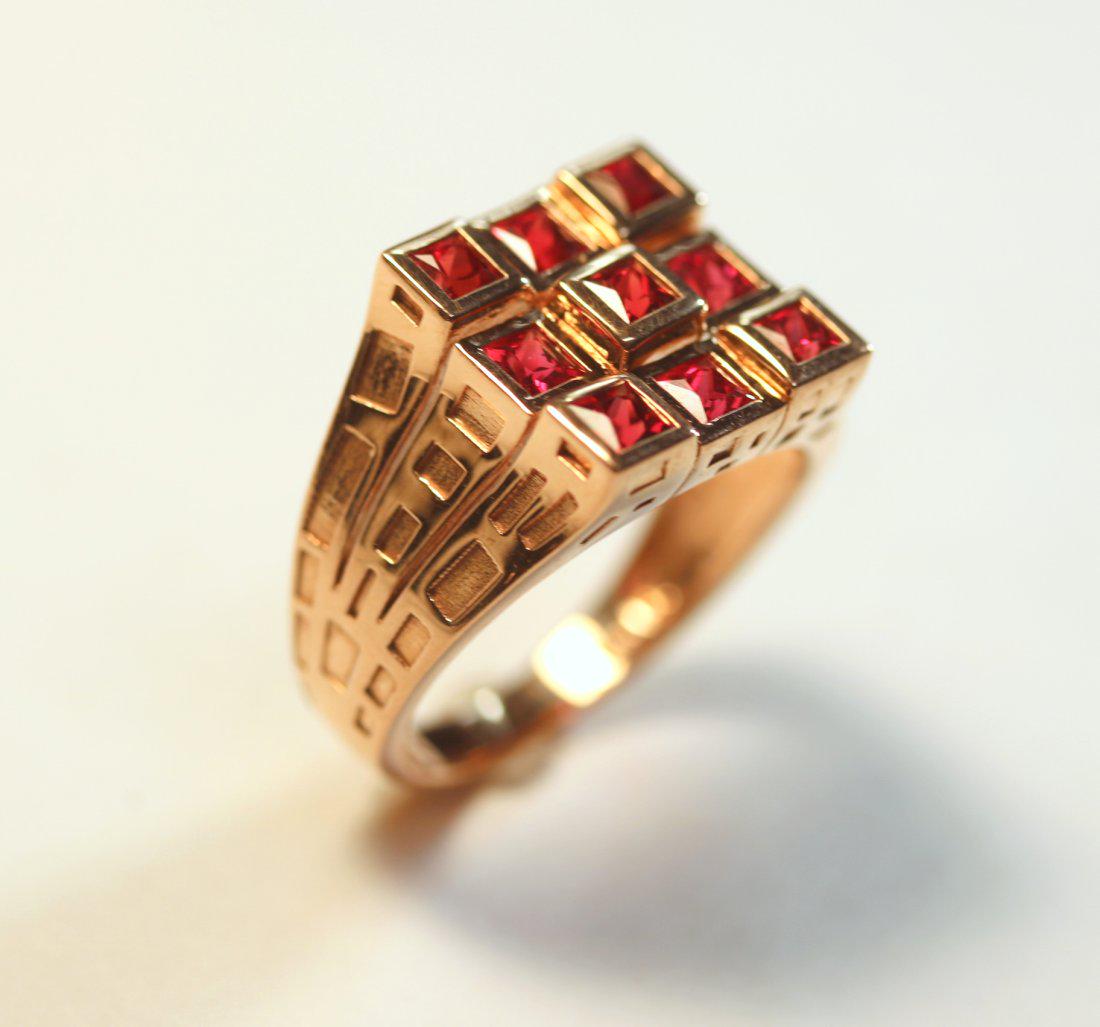 14K Rose Gold with Ruby Ring: 14k rose gold carved shank ring with nine bezel set, square rubies. TW of Colored Stones: 1.53ct TW of Ring: 8.14gm Size: 9.25 TW and sizes are Approximate. See accompanying appraisal copy for in-dept