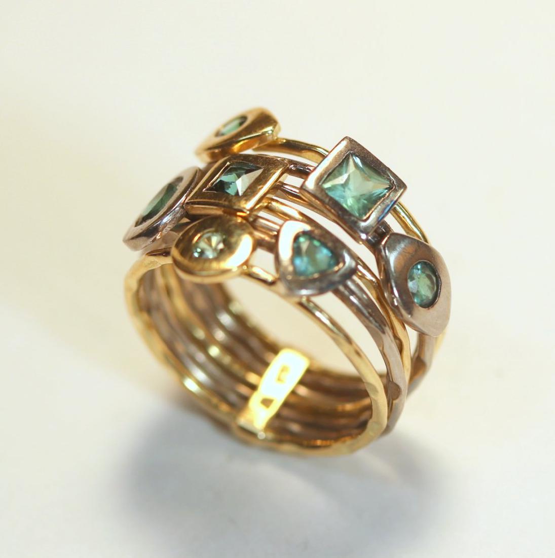 18K White & Yellow Gold Tourmaline Ring: 18Kt ring consisting of seven wires in both white and yellow gold rings set with different shaped, bezel set, tourmaline gemstones. TW of Colored Stones: 0.83ct TW of Ring: 7.71gm Size: 6 TW and sizes