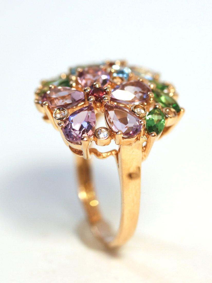 Floral Motif 14K Yellow Gold Gemstone Ring: 14K yellow gold floral motif ring set with five pear cut blue topaz, five pear cut amethysts, six marquise cut diopsides, two round cut rhodolite garnets, eleven round cut white sapphires. TW of Stone