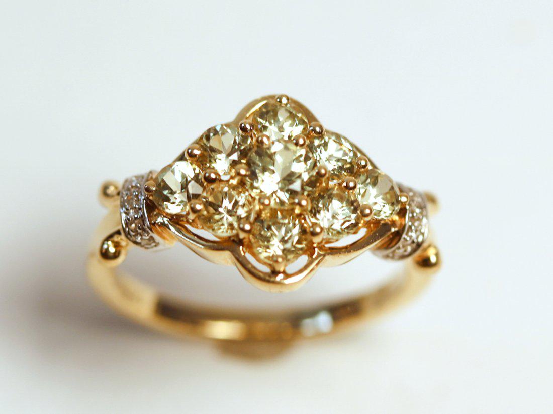 14K Yellow Gold Zultanite & Diamond Ring: 14K yellow gold floral cluster with seven round cut Zultanite gemstone accented with 10 round brilliant cut diamonds. TW of Colored Stones: 1.15ct TW of Diamonds: 0.03ct TW of Ring: 3.28gm Size: 6 TW 