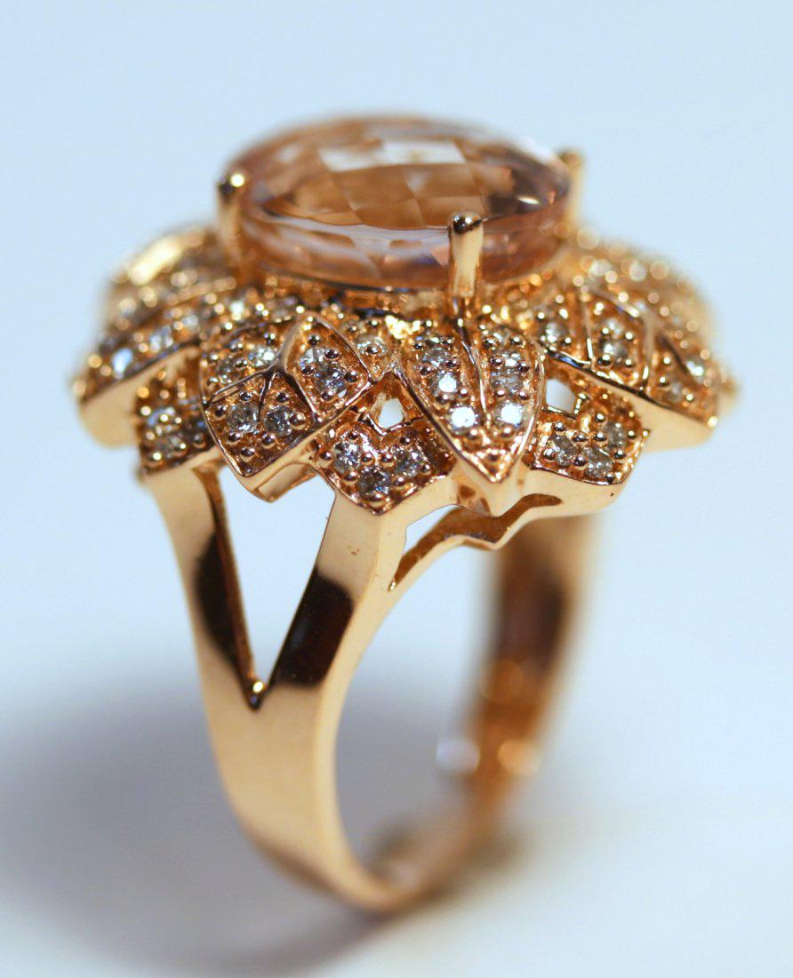 14K Rose Gold Morganite & Diamond Ring: High polish 14k rose gold ring featuring an oval, modified mixed cut morganite gemstone. Surrounding center stone is a leaf motif design with ninety-six diamonds bead set throughout. TW of Colored Sto