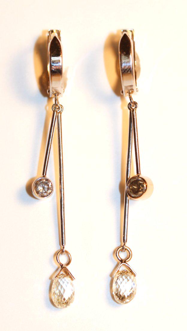 14K White Gold & Diamond Earrings: 14k white gold hoop style, huggy pierce earrings. Two dangling bars are set at ends with a briolette cut dark grey diamond on one and a bezel set round brilliant cut diamond on the other. TW of Diamon