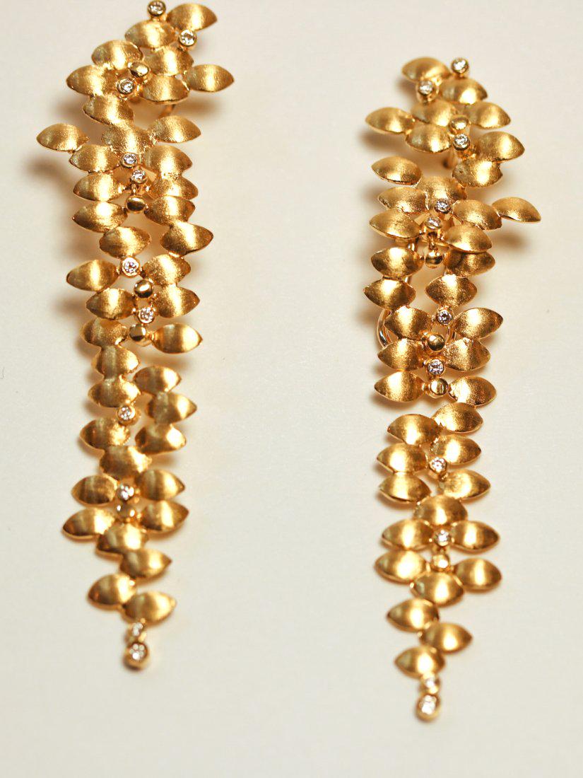 18K Satin Finish Yellow Gold Earrings Leaf Design with: 18k yellow gold with satin finish earrings with omega clip backs with posts. Sporadically placed leaf shapes with eleven round brilliant diamonds are set into each earring. Color: H-I Clarity: SI-1 to