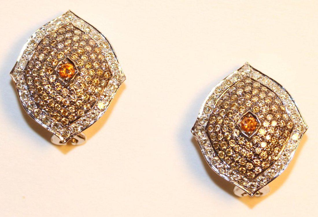 14K White Gold Earrings with White & Light Brown: 14k white gold earrings with omega clip backs with posts. Each earring features a fancy dark brownish-yellowish, bezel set, round brilliant cut diamond centered on the earring. Surrounding are eighty-