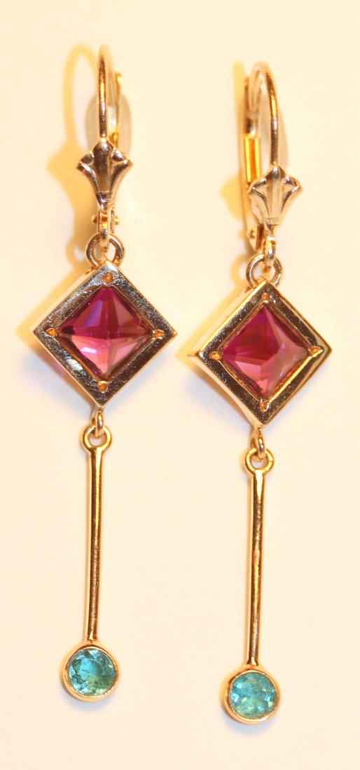 14K Yellow Gold Drop Grape Garnet & Paraiba Tourmaline: 14k yellow gold earrings with pierced lever back finding with a drop grape garnet bezel set in yellow gold with a drop bar featuring a bezel set tourmaline. TW of Colored Stones: 2.22ct TW of Earrings