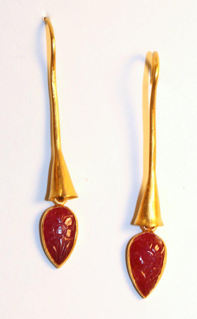 22K Yellow Gold Carved Ruby Earrings: 22k yellow gold earrings with continued shepherd hook extending to cone. Dangling at end is a bezel set, carved ruby gemstone. TW of Colored Stones: 5.32ct TW of Earrings: 8.75gm TW and sizes are Appr