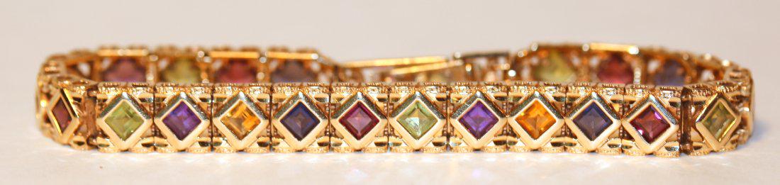 Square-Cut Mulit-Gemstone 14K Yellow Gold Bracelet: 14k yellow gold bracelet with twenty-three square cut gemstones, including peridot, rhodolite garnets, iolites, amethysts, and citrine quartz. 8" long. TW of Colored Stones: 3.81ct TW of Bracelet: 15.