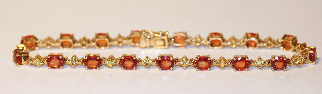 Orange & Yelllow Sapphire 14K Yellow Gold Bracelet: 14k yellow gold bracelet with orange and yellow sapphires. Consist of seventeen oval cut orange sapphires, each separated by a yellow sapphire. 8.5" long. TW of Colored Stones: 1.80ct TW of Bracelet: 