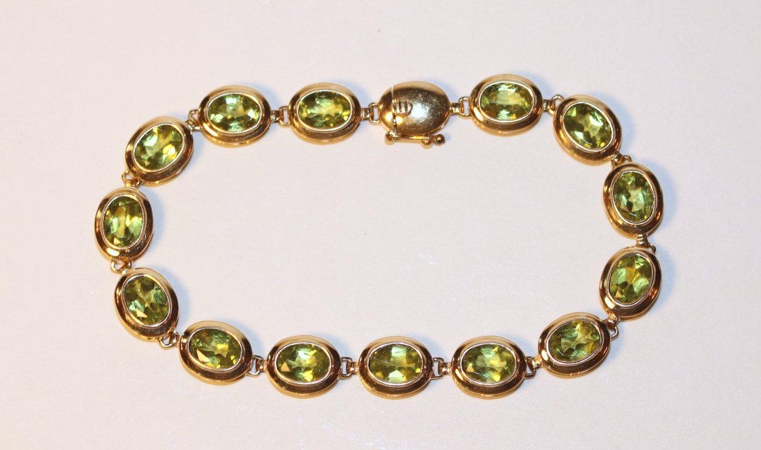 Bezel Set Peridot 14K Yellow Gold Bracelet: 14k yellow gold bracelet with fourteen bezel-set, peridot gemstones. 7.5" long. TW of Colored Stones: 14.42ct TW of Bracelet: 11.66gm TW and sizes are Approximate. See accompanying appraisal copy for 
