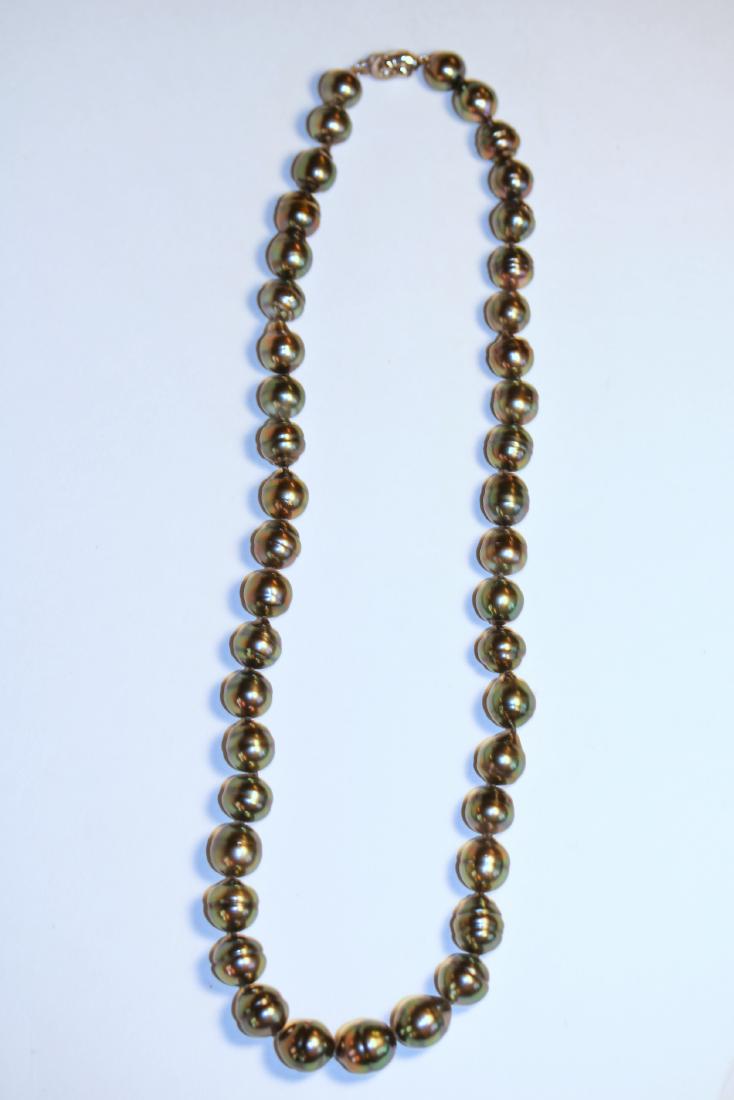 Tahitian Pearl Strand: Single strand necklace of forty-three Tahitian pearls, the measurement is 8.47 to 10.5mm. Pearls are peacock in color with a very good luster, semi-baroque, and moderately blemished with good matching
