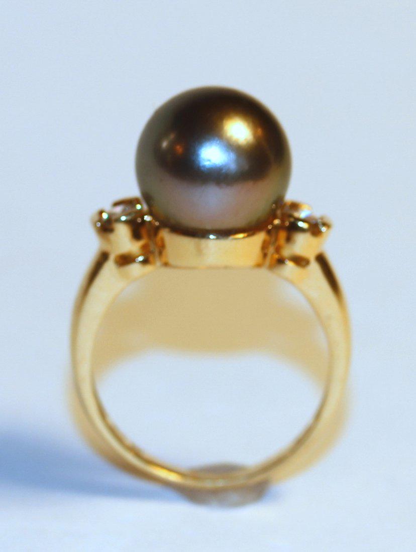 Tahitian Pearl & Diamond 18K Yellow Gold Ring: 18k yellow gold ring featuring one Tahitian pearl. Pearl is peacock color with roseâ€™ overtone and very good luster, round to nearly round and mostly clean. Accented with two, round brilliant cu
