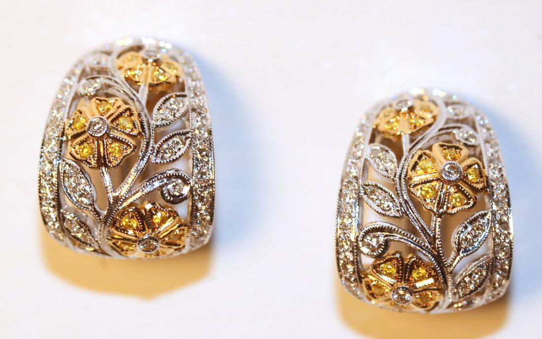 18K White & Yellow Gold Diamond Floral Earrings: 18K white & yellow gold diamond Earrings with omega clip backs. Each earring has three yellow gold flowers, each with five, bead-set, round brilliant cut yellow diamonds and a bezel-set, round brillia