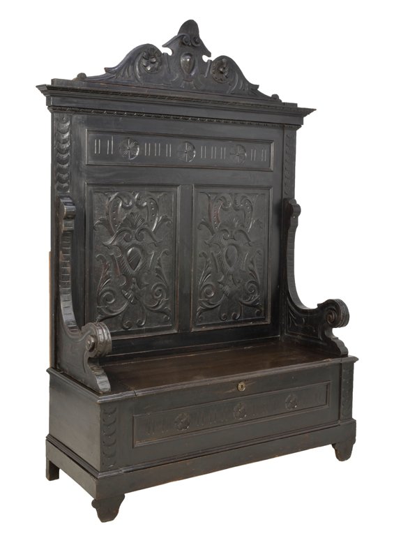 AN ANTIQUE RENAISSANCE REVIVAL STYLE CARVED AND EBONIZE: AN ANTIQUE RENAISSANCE REVIVAL STYLE CARVED AND EBONIZED OAK STORAGE BENCH 19th Century, Italy An antique ebonized bench having an everted stepped cornice, a carved reed and medallion floret frieze, w