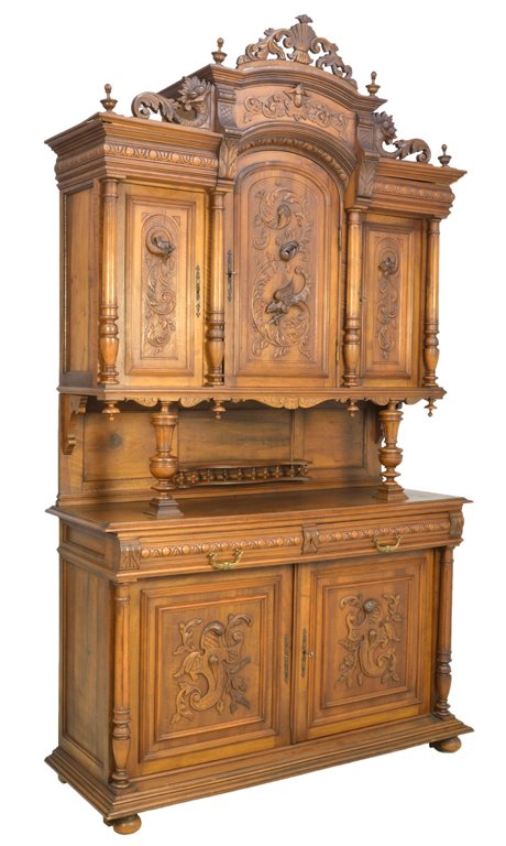 A FRENCH VICTORIAN STYLE WALNUT BUFFET WITH DRAGON AND : A FRENCH VICTORIAN STYLE WALNUT BUFFET WITH DRAGON AND PHOENIX Early 20th Century, France The arched, stepped crest is highlighted by scrolling foliate above a stepped, recessed cornice surmounting an