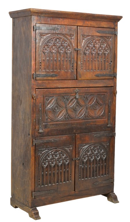 AN ANTIQUE RUSTIC GOTHIC STYLE CARVED OAK SECRETARY DES: AN ANTIQUE RUSTIC GOTHIC STYLE CARVED OAK SECRETARY DESK CABINET 19th Century An antique rustic Gothic style oak secretary having a stepped cornice, with two upper carved panel doors features arches w