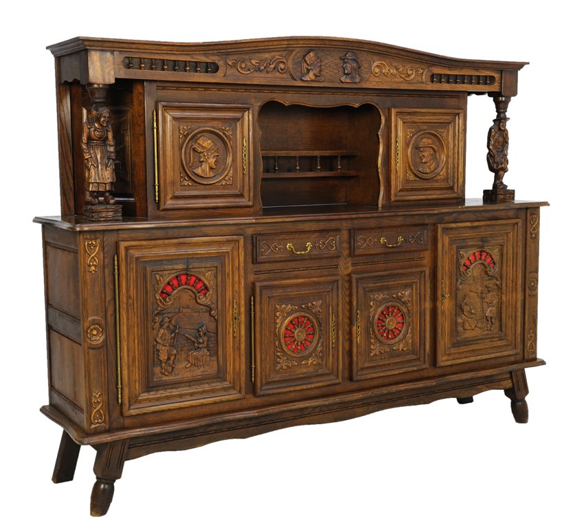 A BRITTANY BUFFET WITH FIGURAL DETAILS: A BRITTANY BUFFET WITH FIGURAL DETAILS The arched cornice features figural portraits at frieze flanked by a spindle gallery surmounting locking cabinets with interior shelving and carved figural suppo