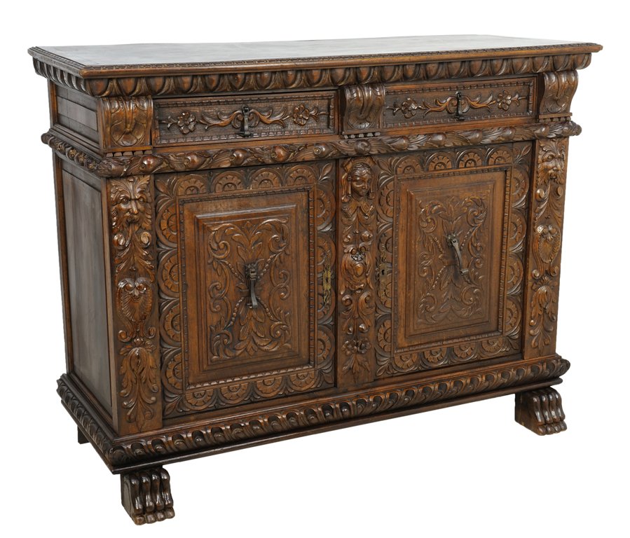 A VICTORIAN RENAISSANCE REVIVAL STYLE OAK BUFFET WITH B: A VICTORIAN RENAISSANCE REVIVAL STYLE OAK BUFFET WITH BUD AND LION PAW Early 20th Century A Renaissance Revival style buffet has a stepped edge with carved detail, having two drawers below with proven