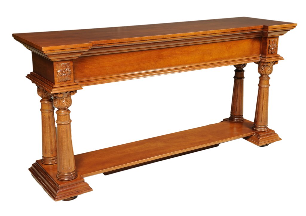 A VICTORIAN STYLE CONSOLE SOFA TABLE: A VICTORIAN STYLE CONSOLE SOFA TABLE 20th Century A long Victorian style console table features an inverted stepped edge, block and roset details, turned and tapered Corinthian uprights, on an open sh