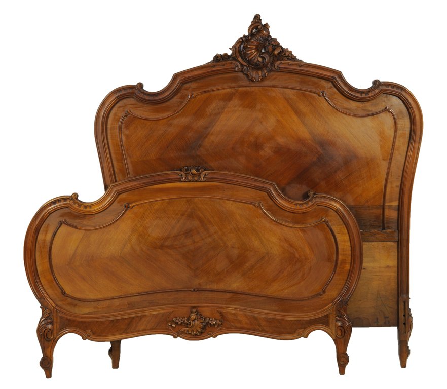 A LOUIS XV STYLE BED WITH DIAMOND PARQUETRY: A LOUIS XV STYLE BED WITH DIAMOND PARQUETRY Early 20th Century The shaped crest highlighted by carved, scroll work surmounts the headboard featuring diamond parquetry bookmatched panels above scrollin